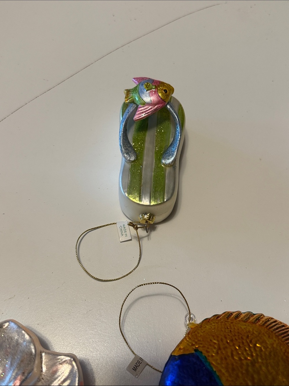 Beach theme glass Christmas ornament in a striped green stripe flip flop.